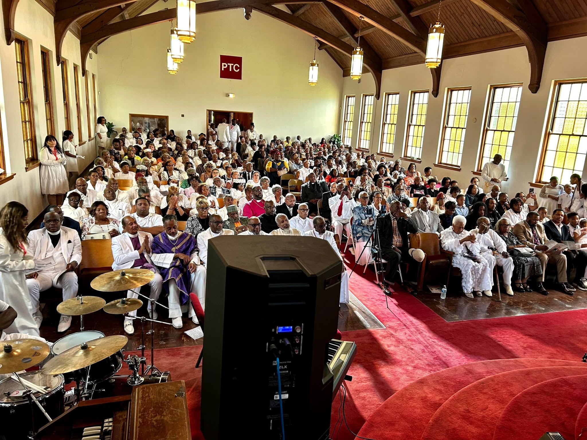 Standing room only — the full PTC congregation gathered in worship